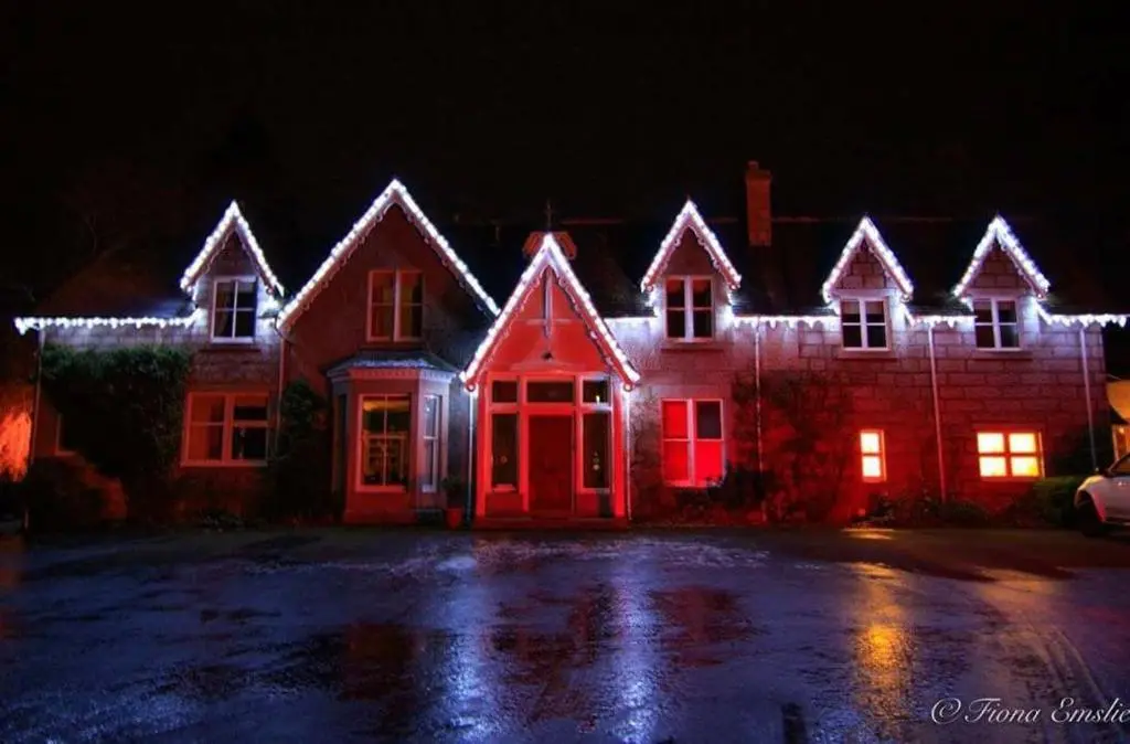 a house with red and white lights on it at The Cabin at No 45 in Ballater