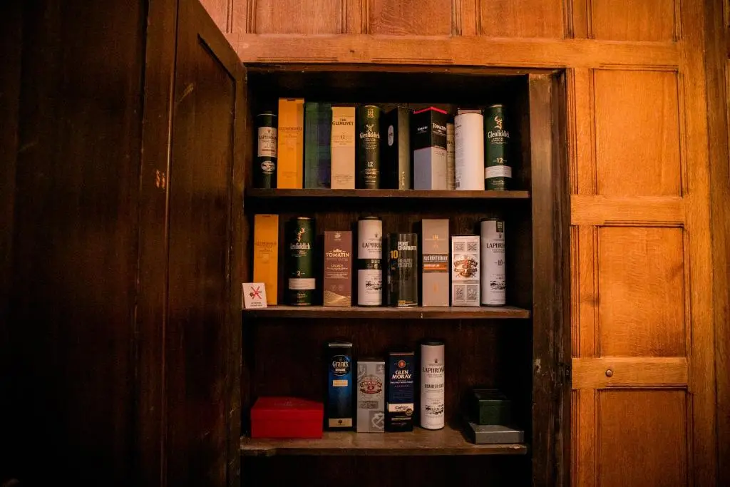 a book shelf filled with lots of books at Scatwell House in Garve