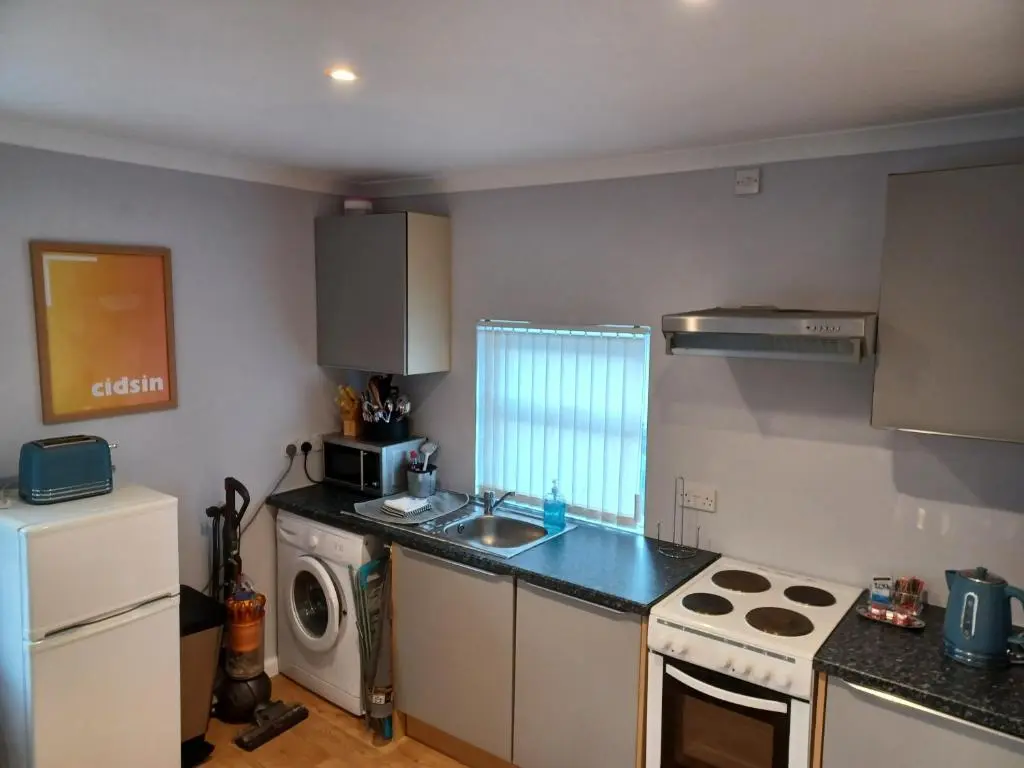 a kitchen with a sink and a stove top oven at The Highland Studio Muir of Ord in Muir of Ord