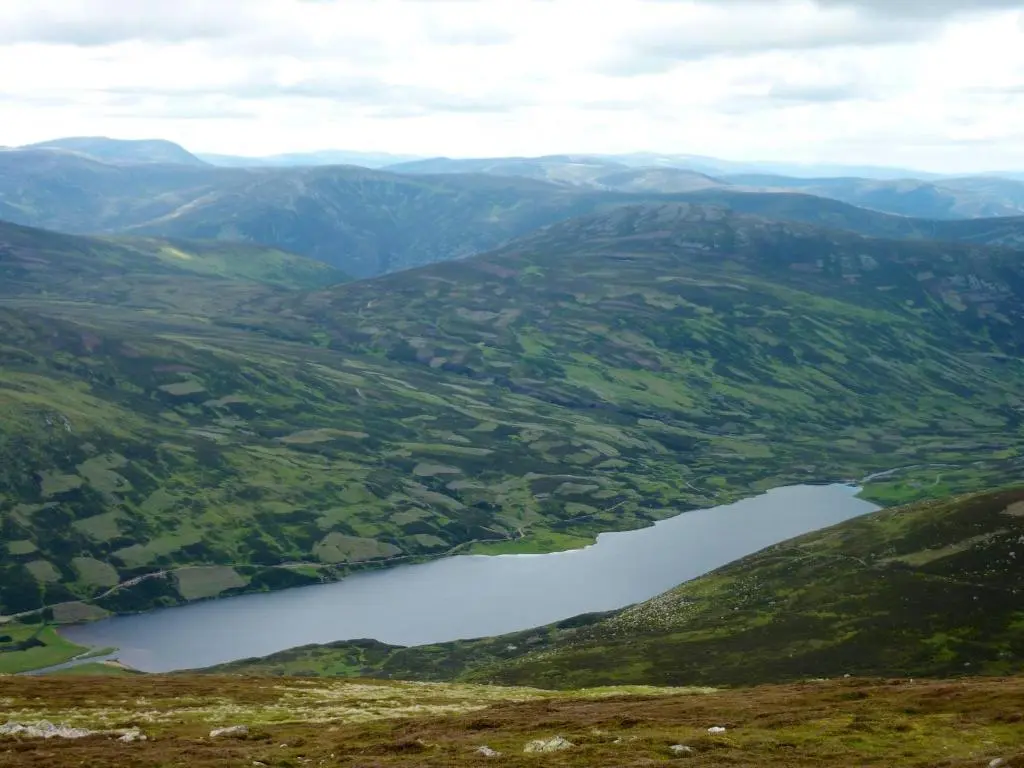 an aerial view of a lake in a valley at Braemar Youth Hostel in Braemar
