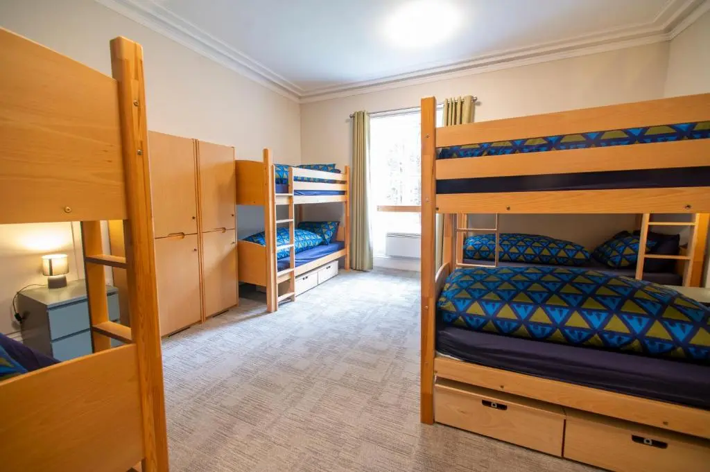 a room with two bunk beds and a bedroom with at Braemar Youth Hostel in Braemar