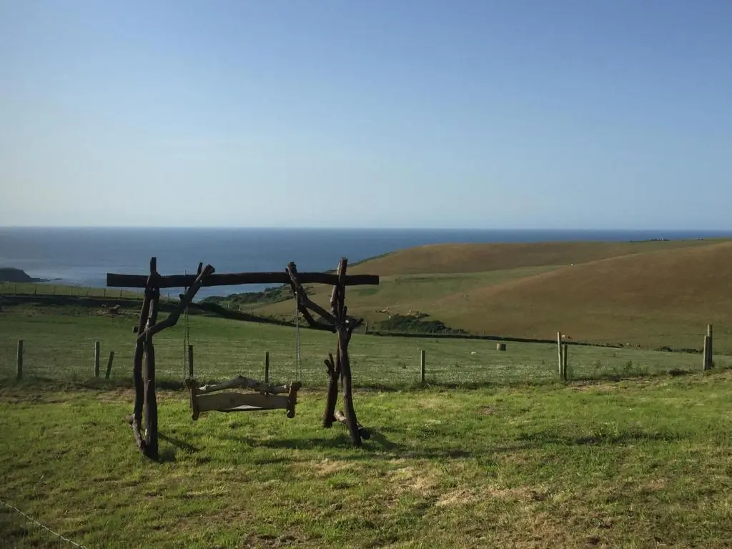 a wooden structure in the middle of a field at Mains Of Auchmedden Cottage in Pennan