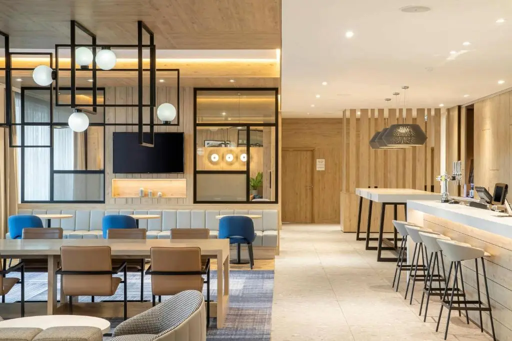 a restaurant with tables and chairs and a bar at Courtyard by Marriott Inverness Airport in Inverness