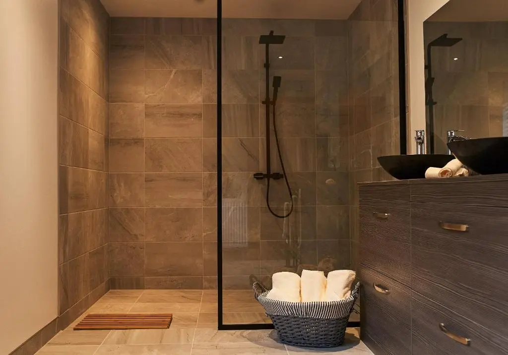 a bathroom with a shower with a glass door at Shoreland Lodges - Holly Lodge in Fort Augustus