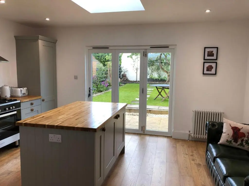 a kitchen with an island in the middle of a room at Fantastic central location in Inverness