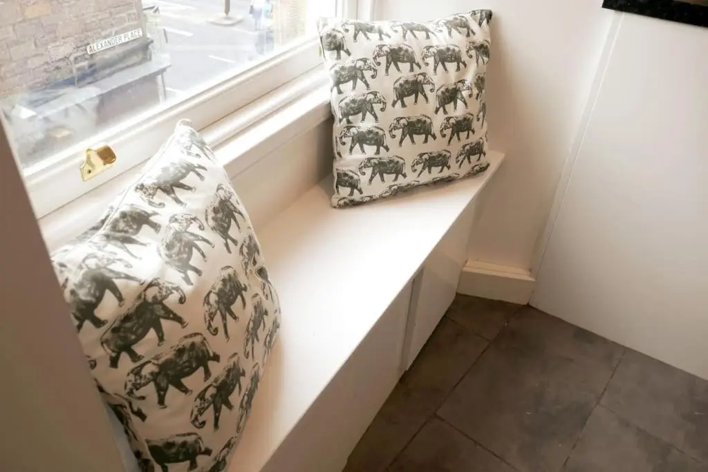 two pillows are sitting on a window sill next to a window sill at Highland Historical Home in Inverness City Centre in Inverness