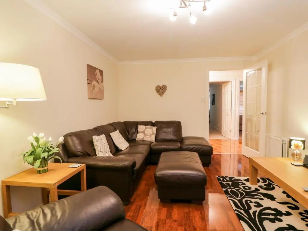 a living room with a couch and a table at 7 Riverside Gardens in Inverness