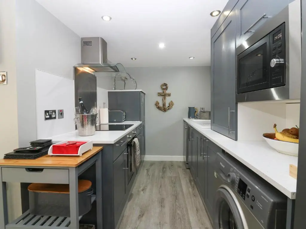 a kitchen with a sink and a dishwasher at 61 Seatown in Buckie