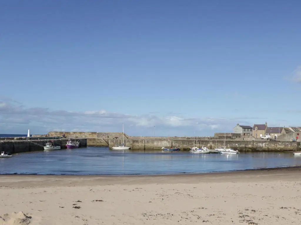 a group of boats are docked in a harbor at 61 Seatown in Buckie