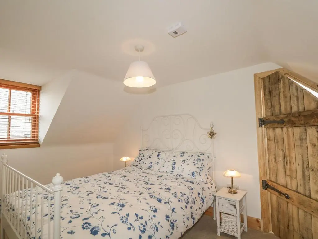 a bedroom with a bed and a wooden door at 11 Village in Banff