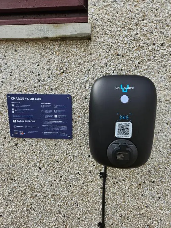 a car meter sitting on the ground next to a sign at The Cobblers in Inverness