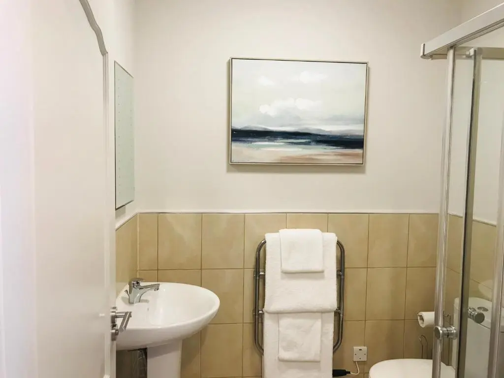 a bathroom with a sink and a toilet at 3 Argyle Place in Dornoch