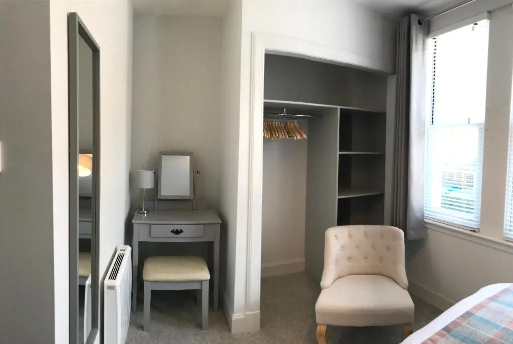 a bedroom with a desk and a chair and a bed at 3 Argyle Place in Dornoch
