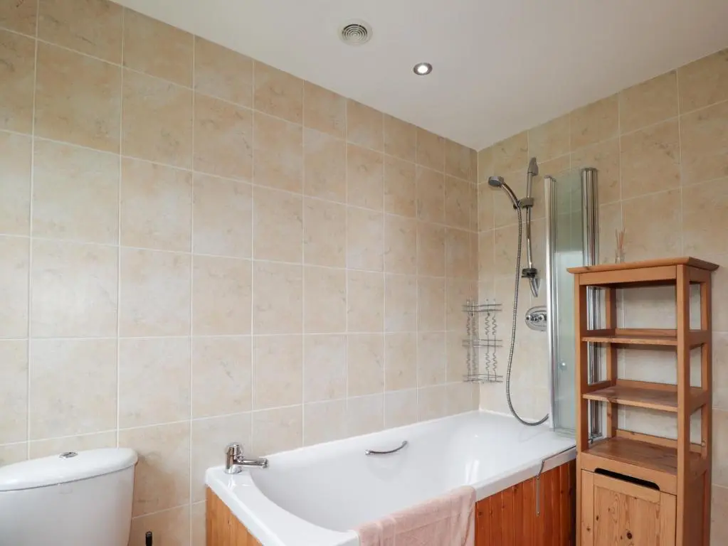 a bathroom with a tub and a toilet and a shower at An Torr in Newtonmore