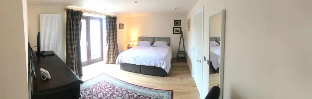 a bedroom with a bed with two pillows on it at Kilmorie House in Elgin