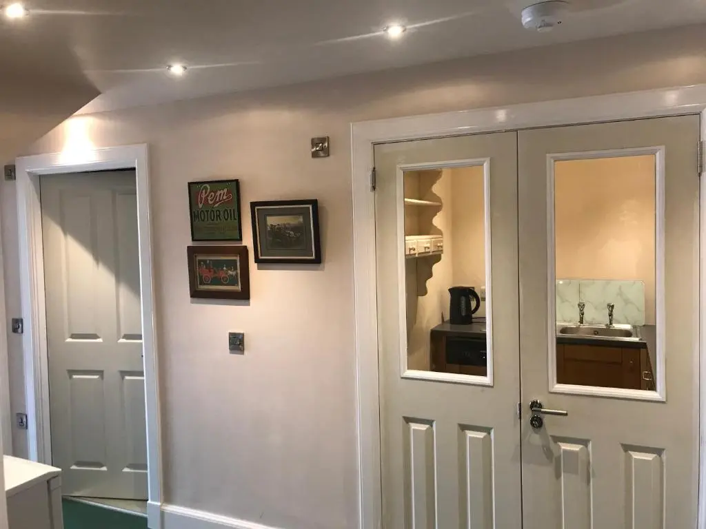 a bathroom with a white door and a sink at Kilmorie House in Elgin