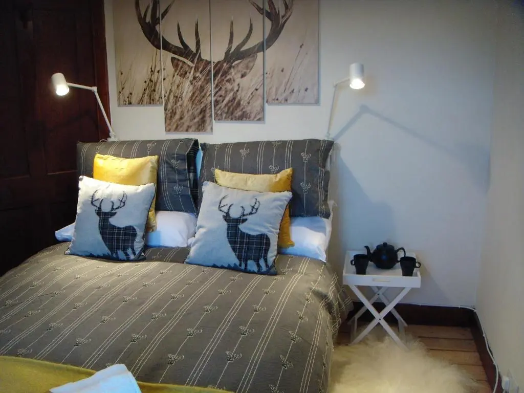 a bedroom with a bed with pillows on it at The Granary in The Square in Grantown on Spey