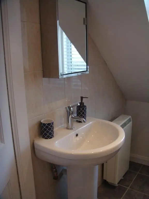 a bathroom with a sink and a mirror at The Granary in The Square in Grantown on Spey