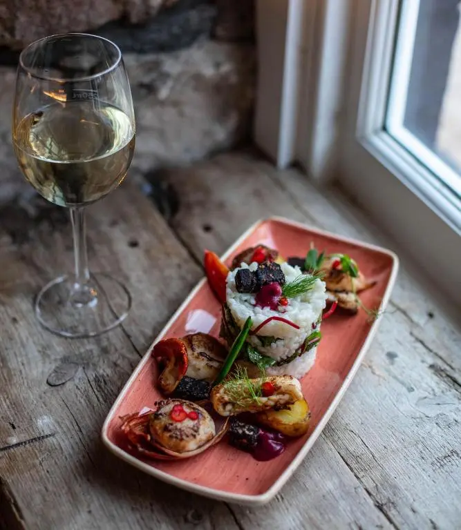 a plate of food next to a glass of wine at Blackfriars in Inverness