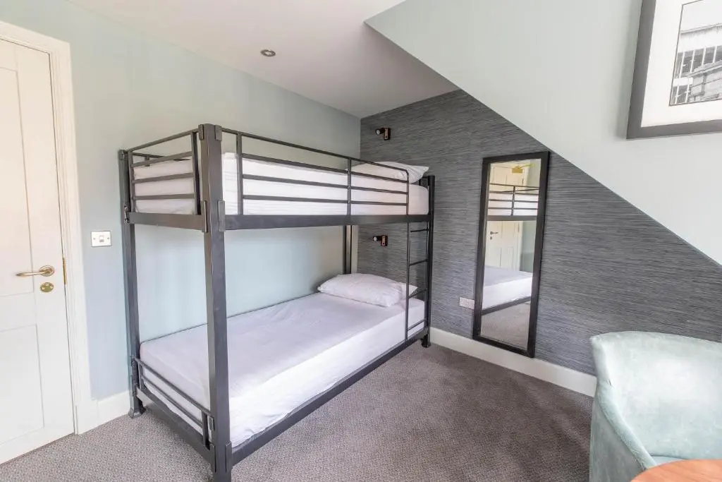 a bunk bed in a room with a staircase at Blackfriars in Inverness