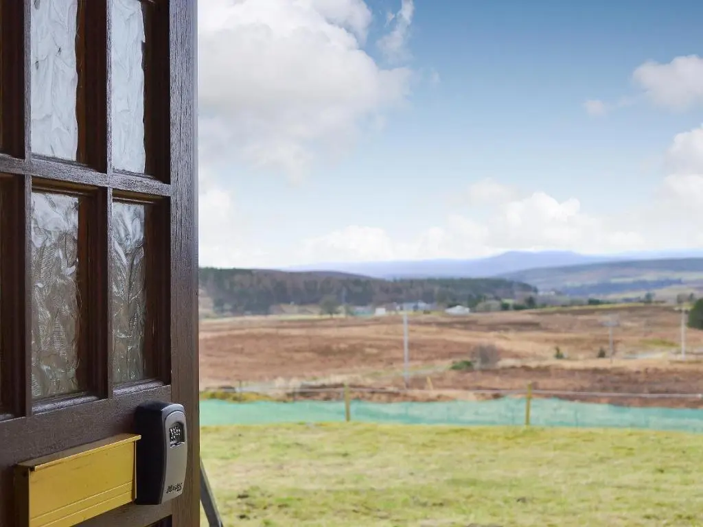 a window with a view of a field at Fair View in Lairg