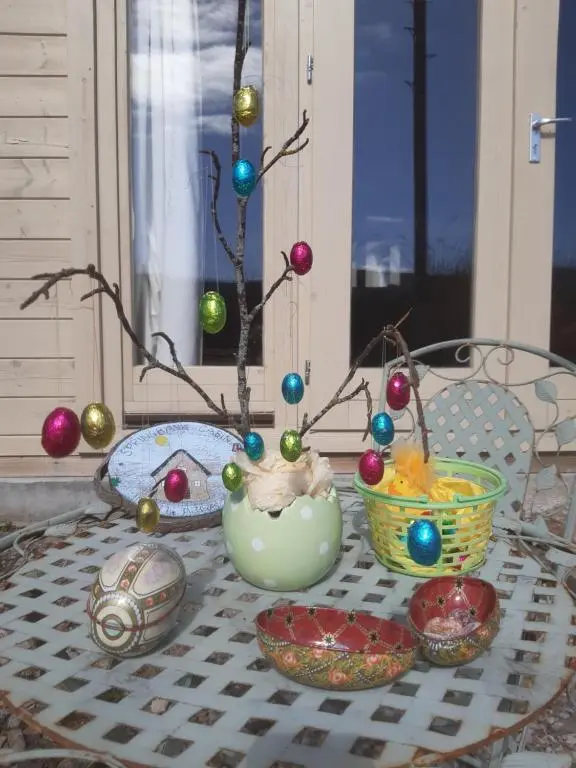 a table with some bowls and ornaments on it at Springbank Cabin in Insch