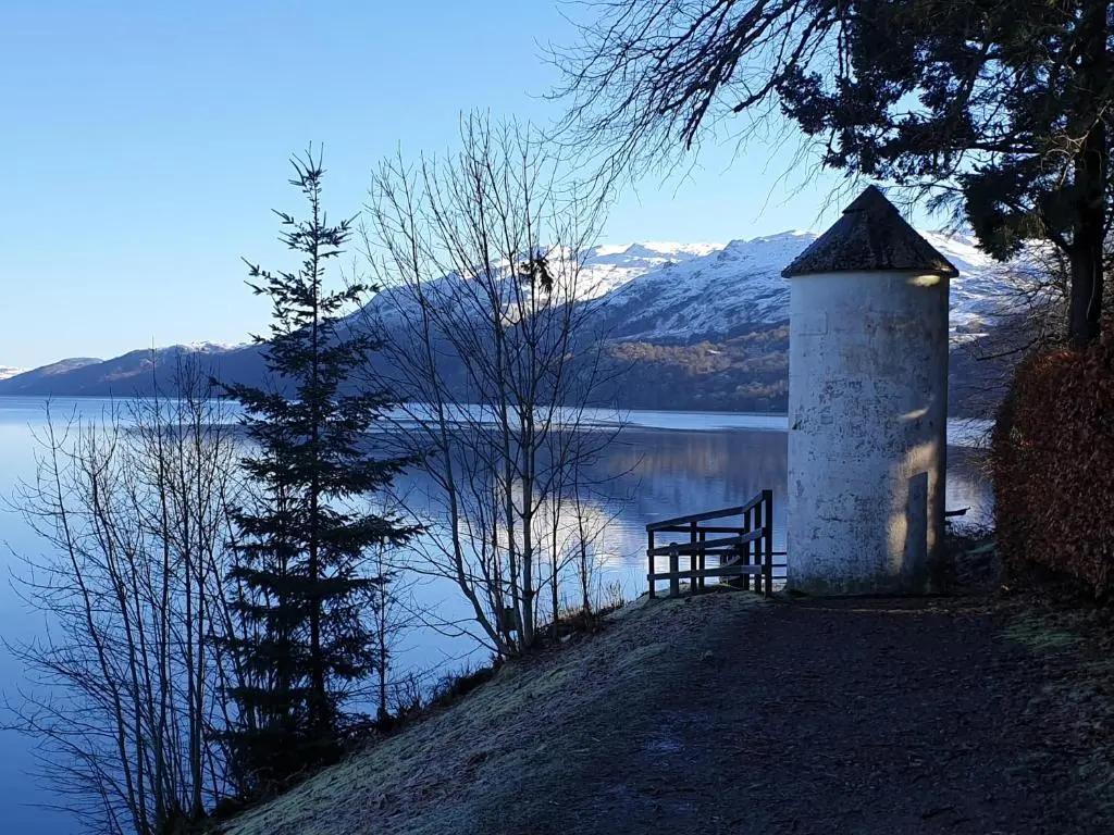 a lighthouse on the side of a body of water at Lorien House B&B in Fort Augustus
