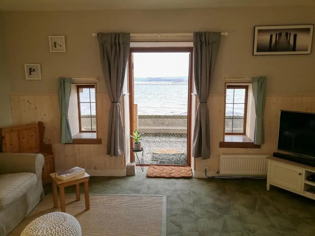 a living room with a view of the ocean at St Brighs in Dingwall