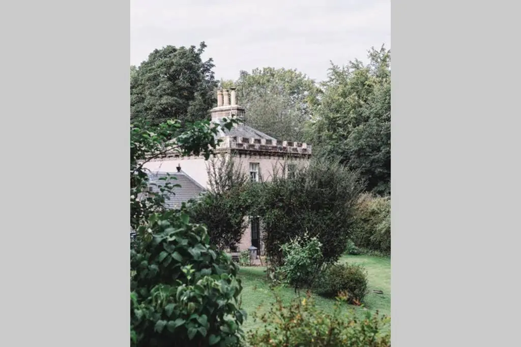 an old house in the middle of a garden at Quarry Gardens Lodge in Fochabers