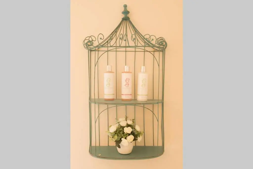a shelf with four candles and a vase with flowers at Quarry Gardens Lodge in Fochabers