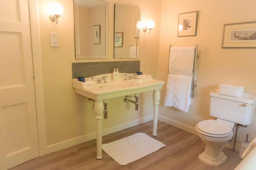 a bathroom with a sink and a toilet at Quarry Gardens Lodge in Fochabers