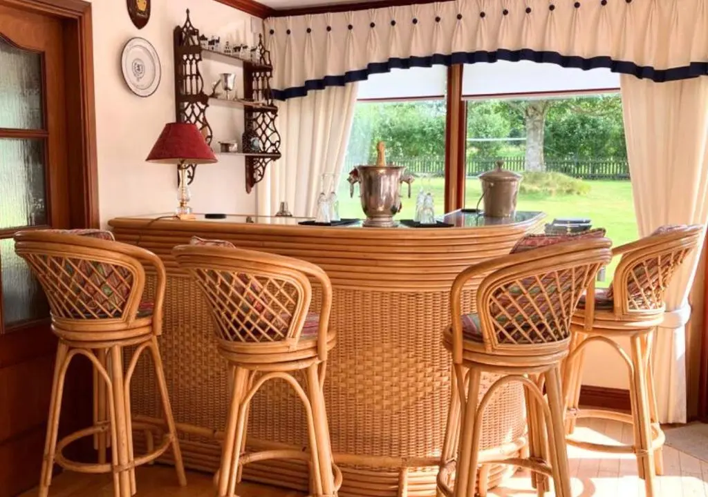 a dining room with a table and four chairs at Stunning 7 Bedroom Bungalow Alford Aberdeenshire in Alford