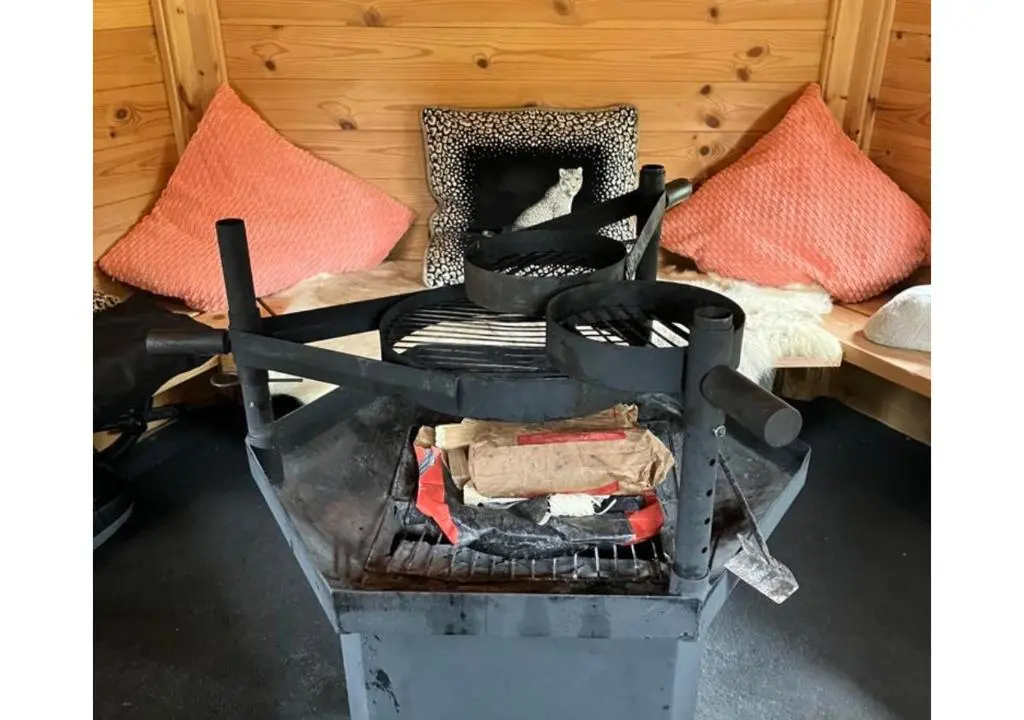 a chair sitting on a stove in a room at Stunning 7 Bedroom Bungalow Alford Aberdeenshire in Alford