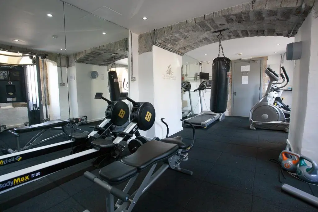 a gym with two treadmills and two exercise bikes at One Bedroom Apartment Highland Club Scotland in Fort Augustus