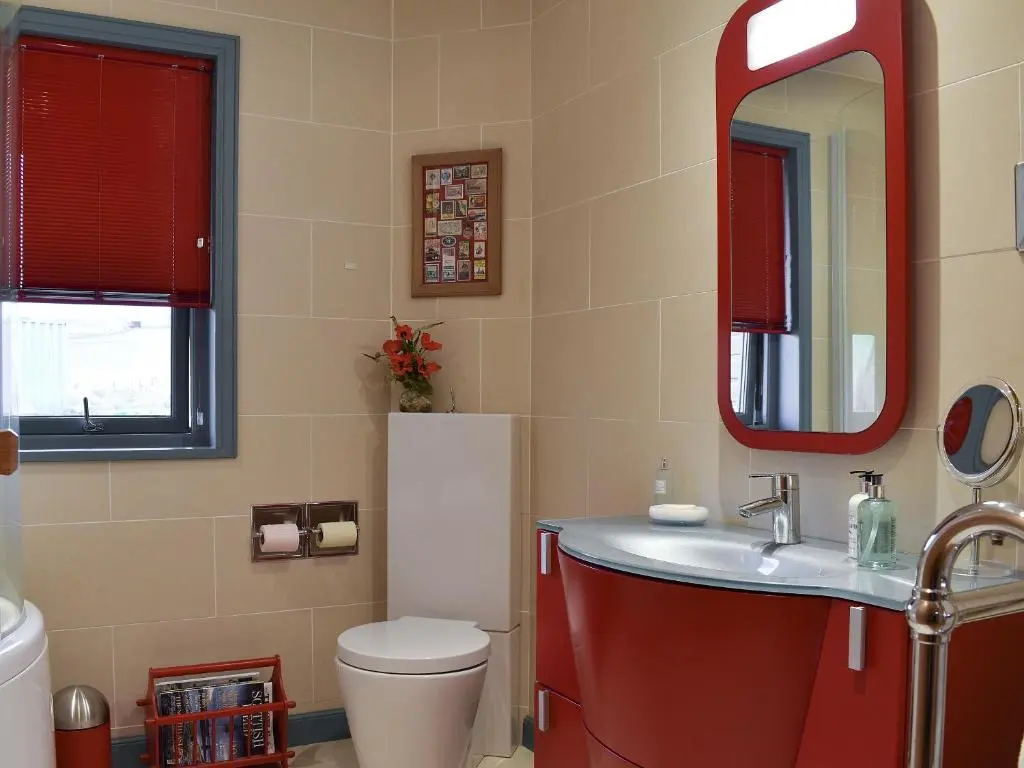 a bathroom with a toilet and a sink and a mirror at Mill Of Burncrook in Glenlivet