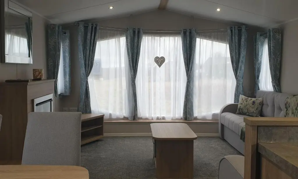 a living room with a couch and a window at Bonnie Gorm in Boat of Garten