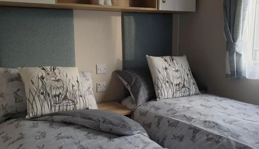 a bedroom with two beds next to each other at Bonnie Gorm in Boat of Garten