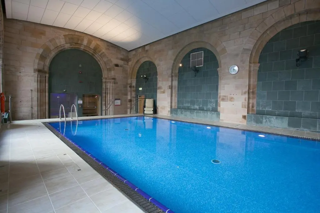 a large swimming pool in a large building at Loch Ness Moat House Apartments in Fort Augustus