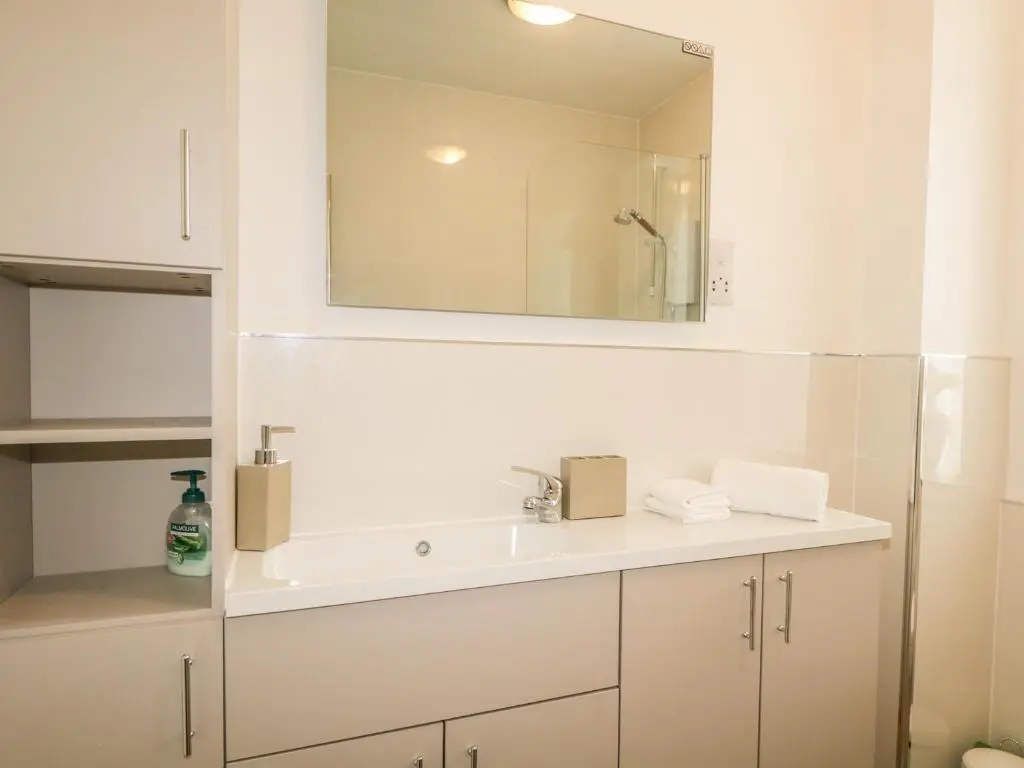 a white bathroom with a sink and a mirror at Faodail Glenlia in Foyers