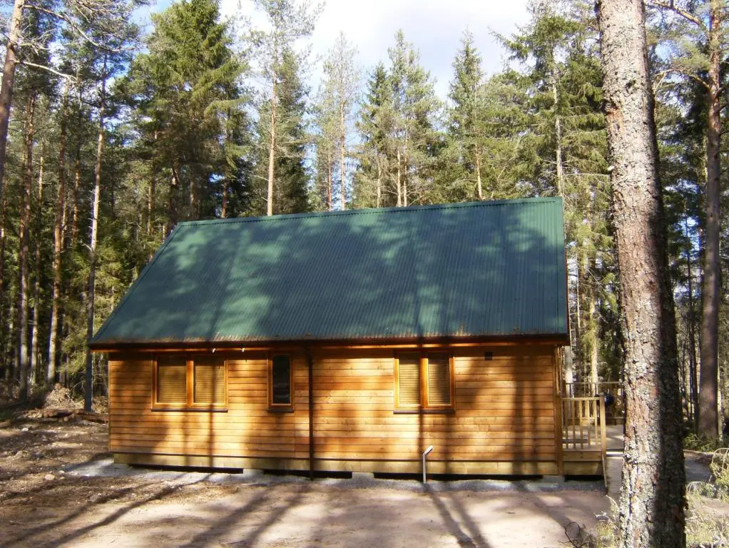 a small wooden cabin in the woods at Cairngorm Lodges in Aboyne