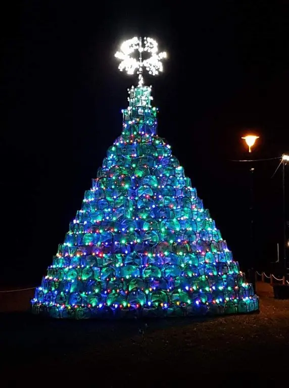 a christmas tree is decorated with blue and green lights at Number 27 in Ullapool