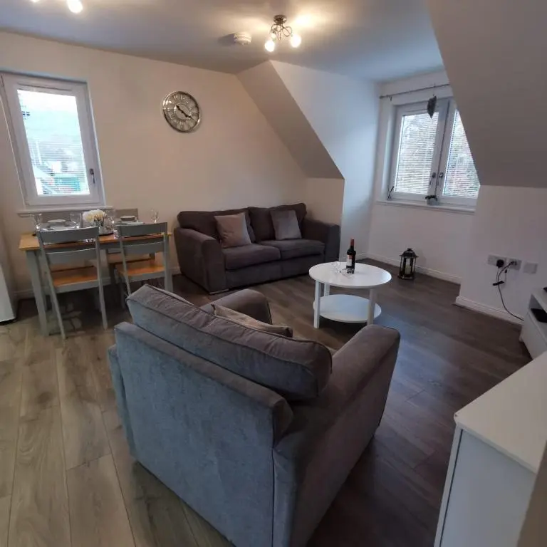 a living room with a couch and a table at Number 27 in Ullapool