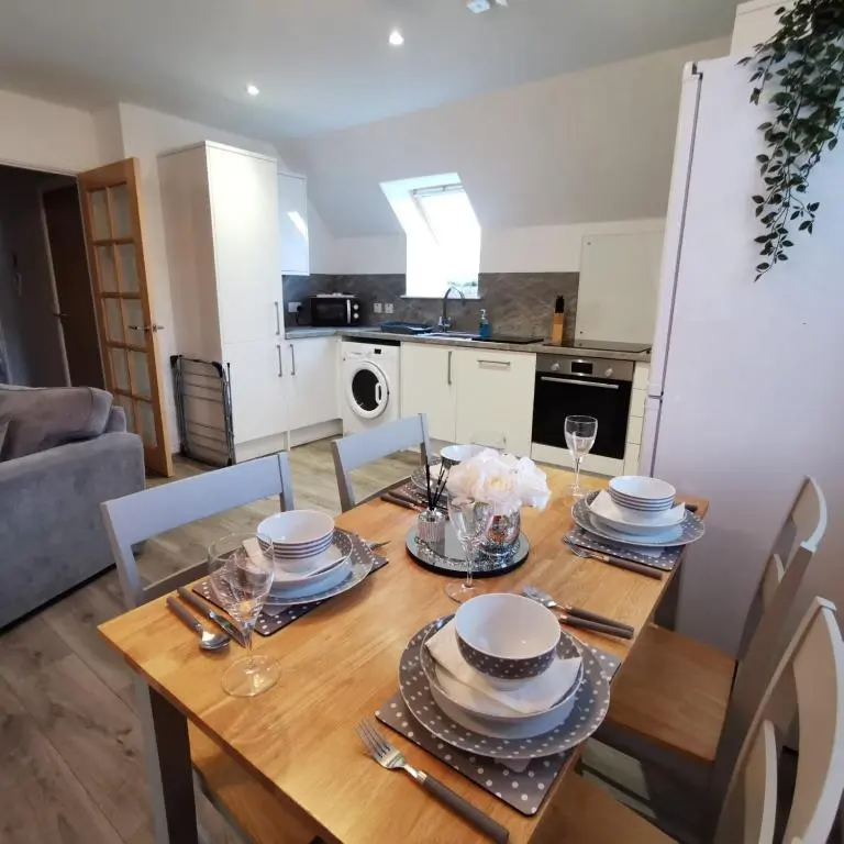 a dining room table with plates and dishes on it at Number 27 in Ullapool
