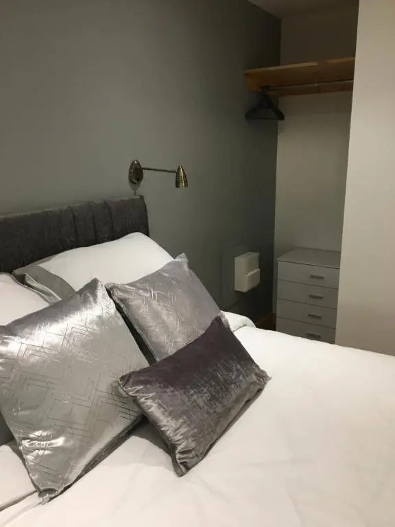 a bed with two silver pillows on it at Grantown Caravan Park in Grantown on Spey