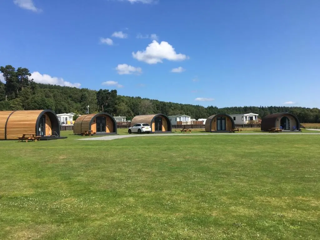 a group of domes in a field with grass at Grantown Caravan Park in Grantown on Spey