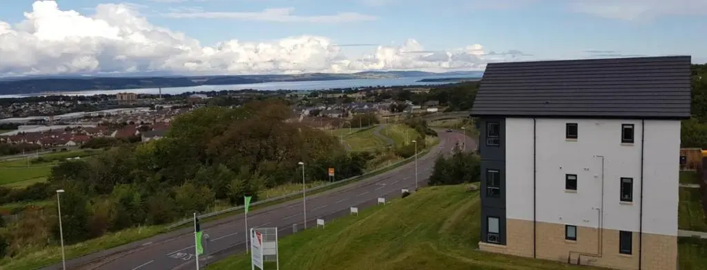 a building on a hill next to a road at Atholl Place View in Inverness