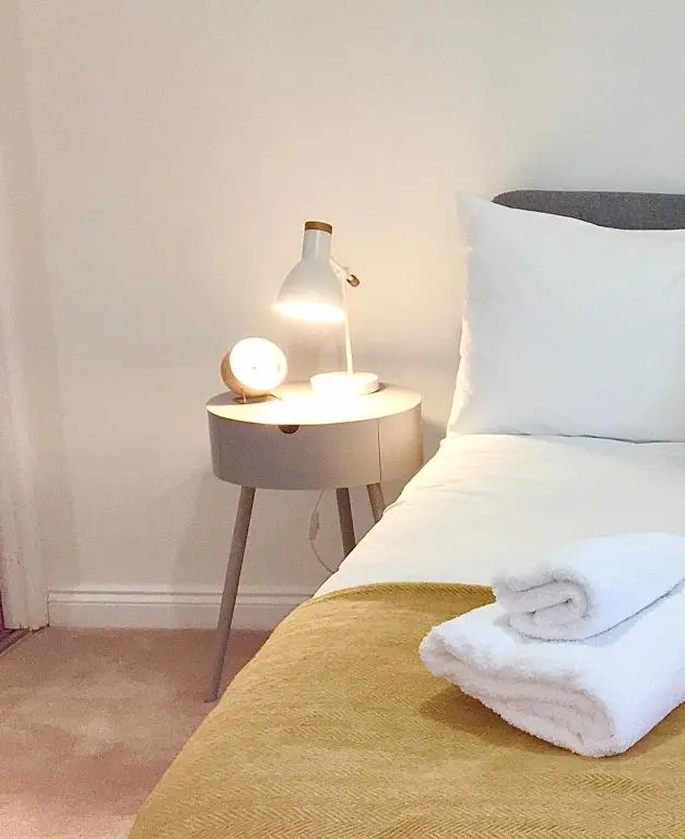 a bedroom with a bed with a lamp on a side table at The Tack Room in Inverness