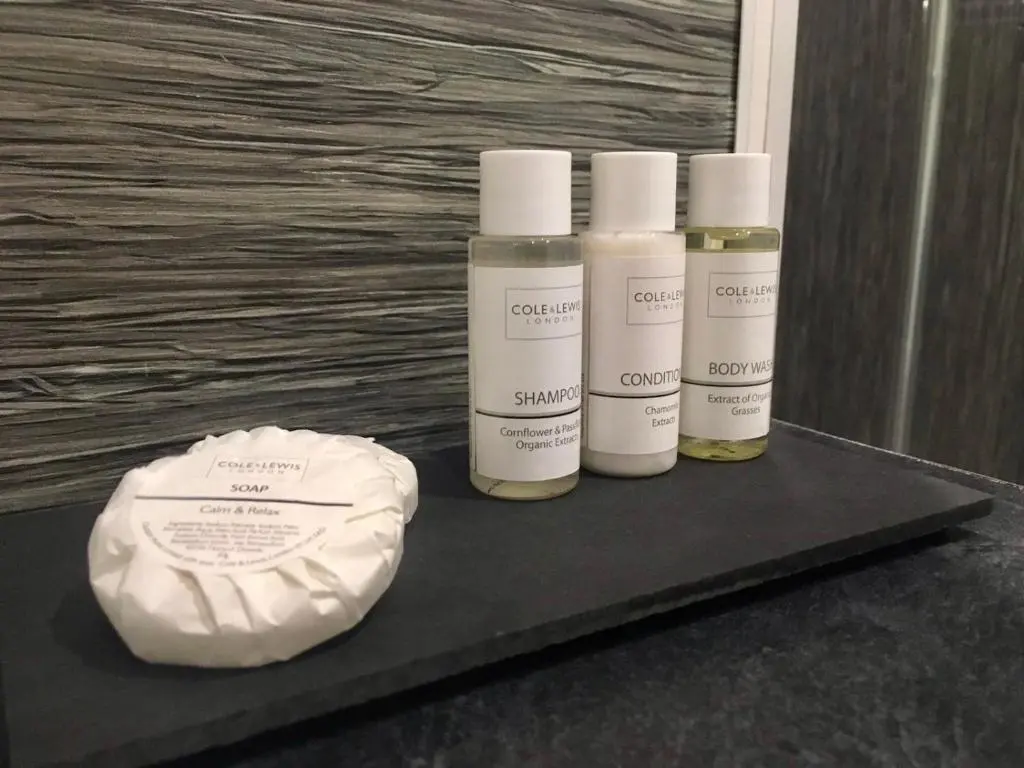 three bottles of moisturizers sitting on a black shelf at The Tack Room in Inverness