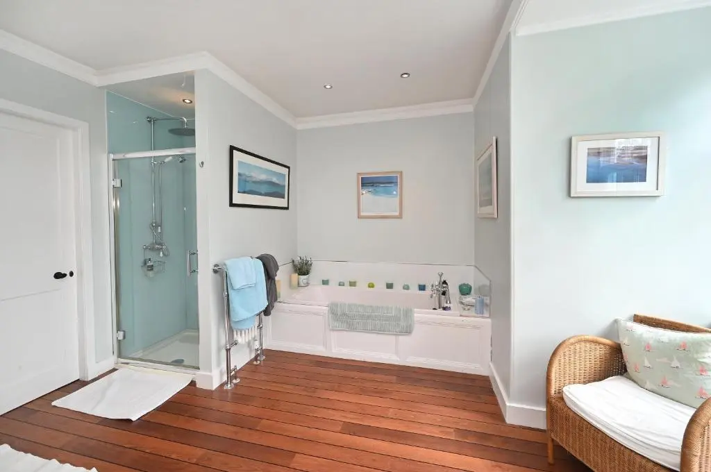 a bathroom with a shower and a bath tub at Willowvale in Nairn