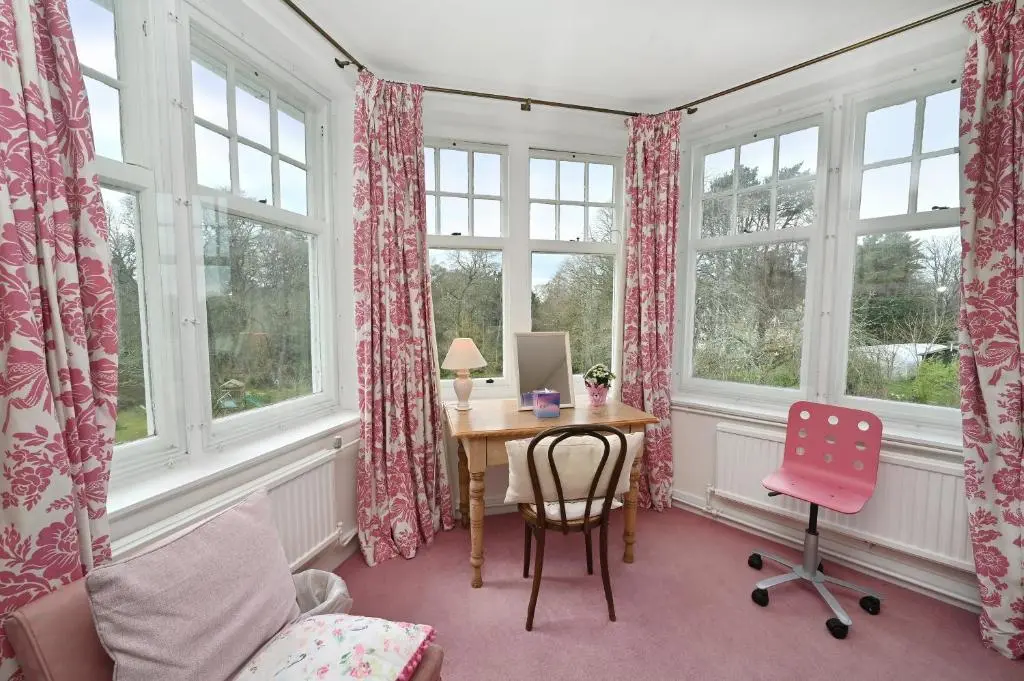 a room with a desk and chairs and windows at Willowvale in Nairn